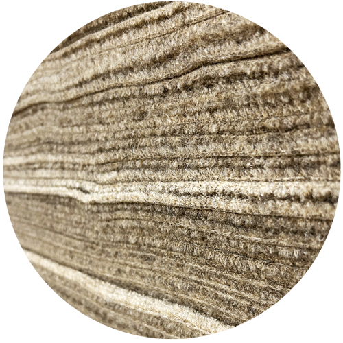 Close-up of textured beige fabric with a circular crop