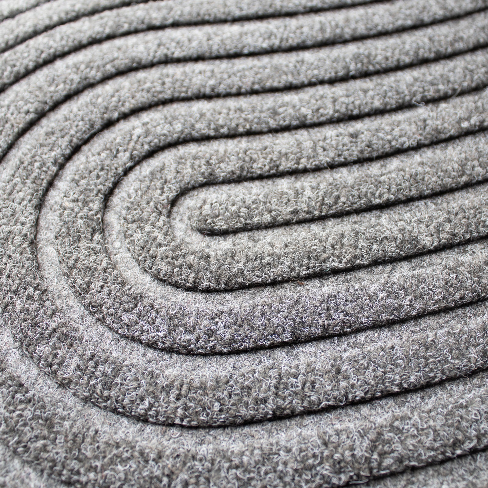 Close-up of grey mat with circular patterns