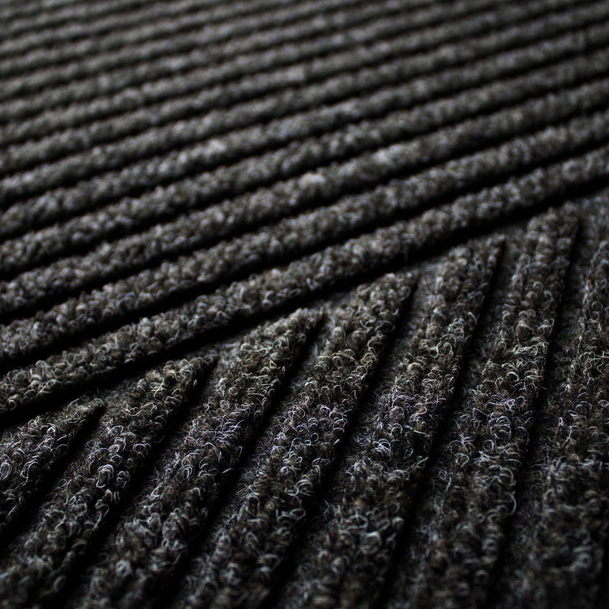 Close-up of textured black fabric with a ribbed pattern