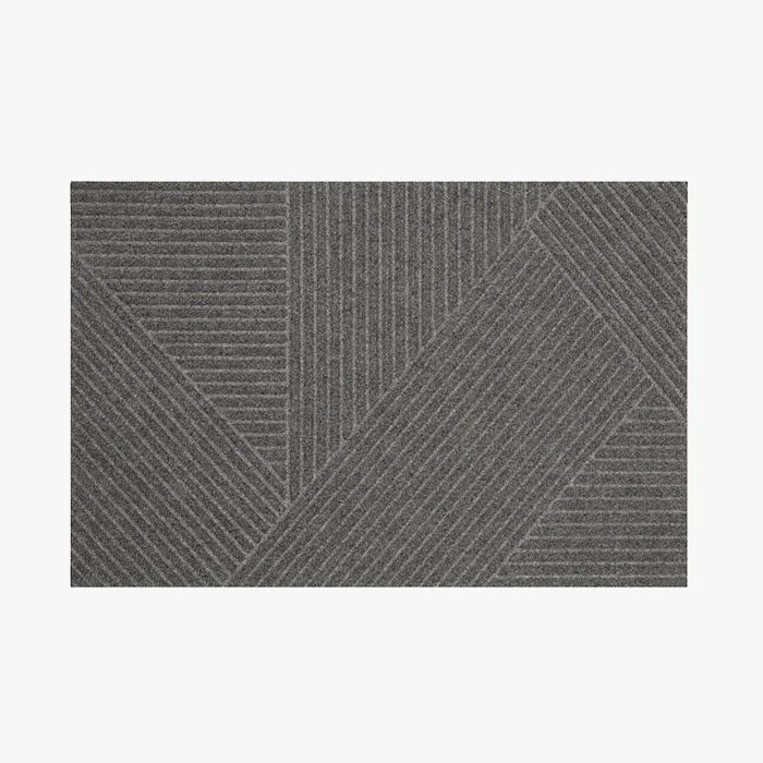 A rectangular doormat with a geometric pyramid pattern in a solid color, likely designed for indoor use.