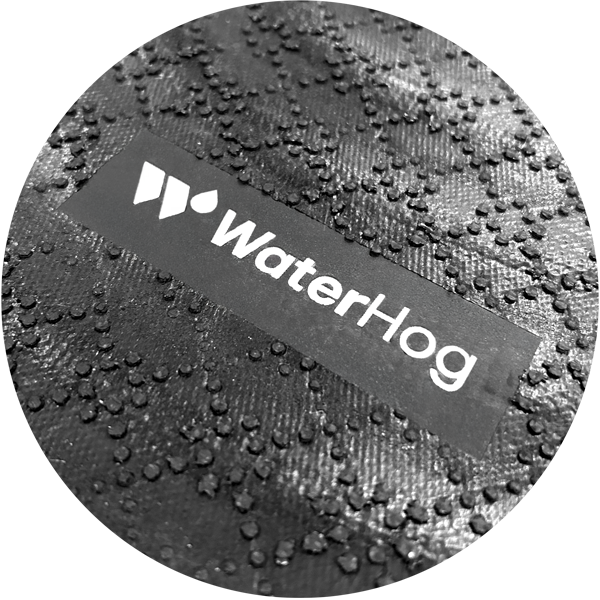 Round mat with 'WaterHog' logo on a textured surface