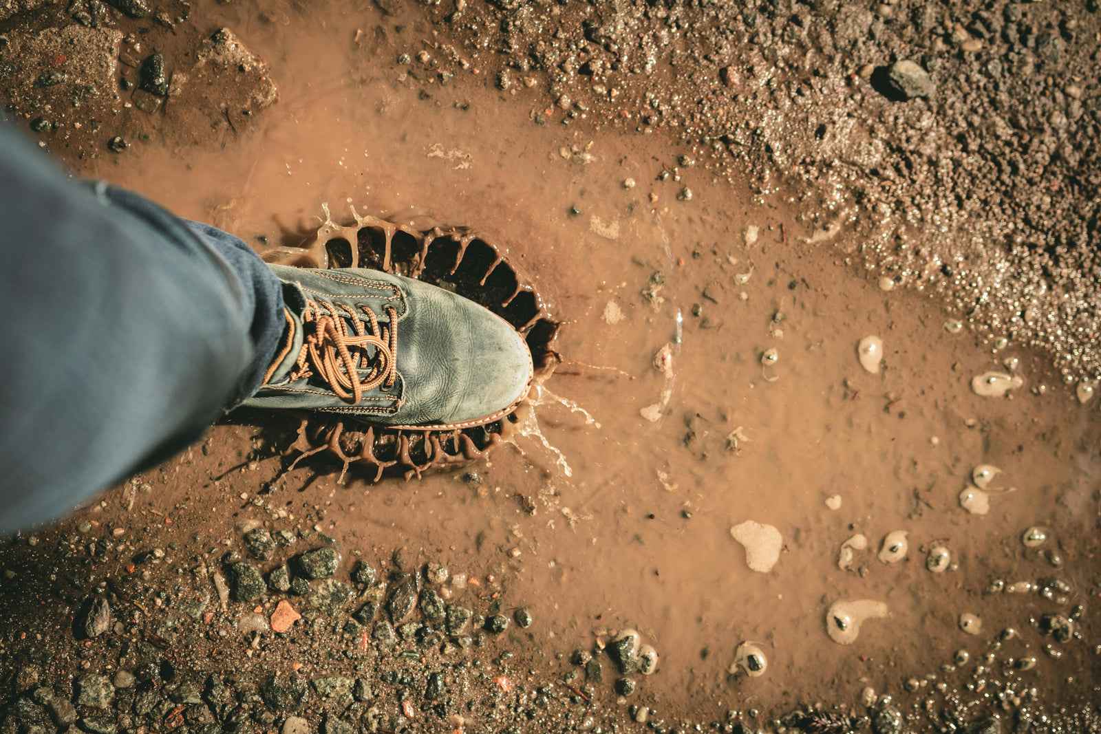 person walking in mud