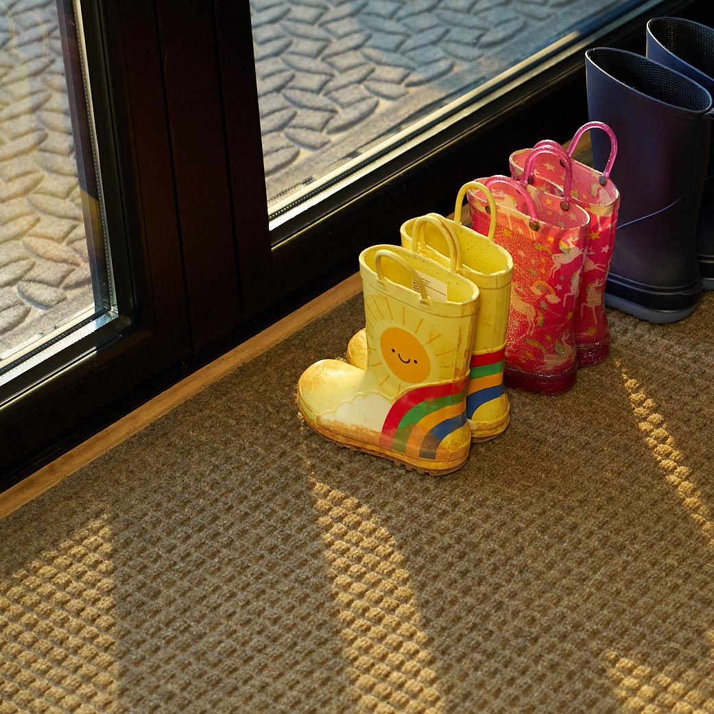 doormat with kids boots on it