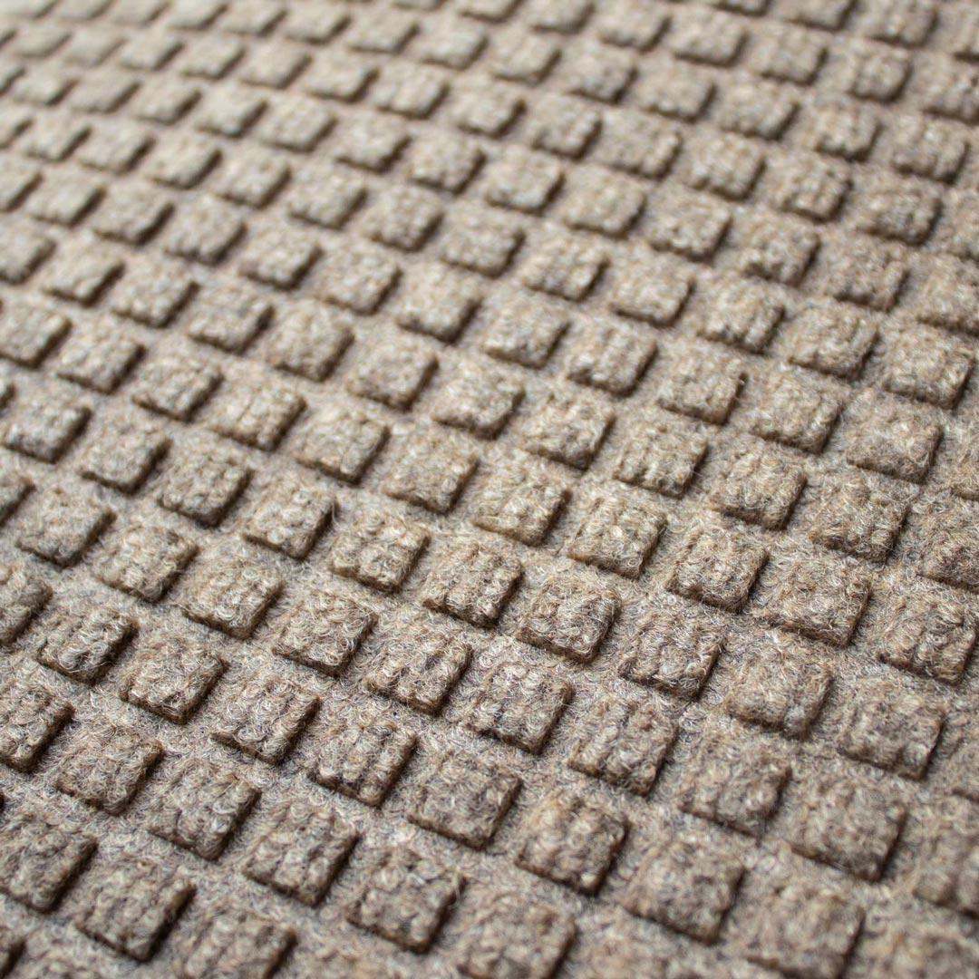 Close-up of a textured brown surface with a grid pattern