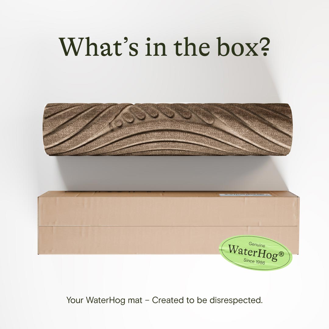 Wooden mat with 'WaterHog' branding on a cardboard box against a white background.